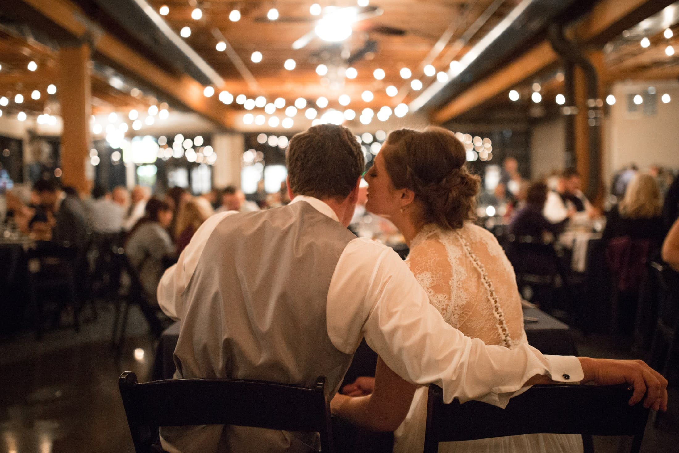 Couple at their reception surrounded by guests