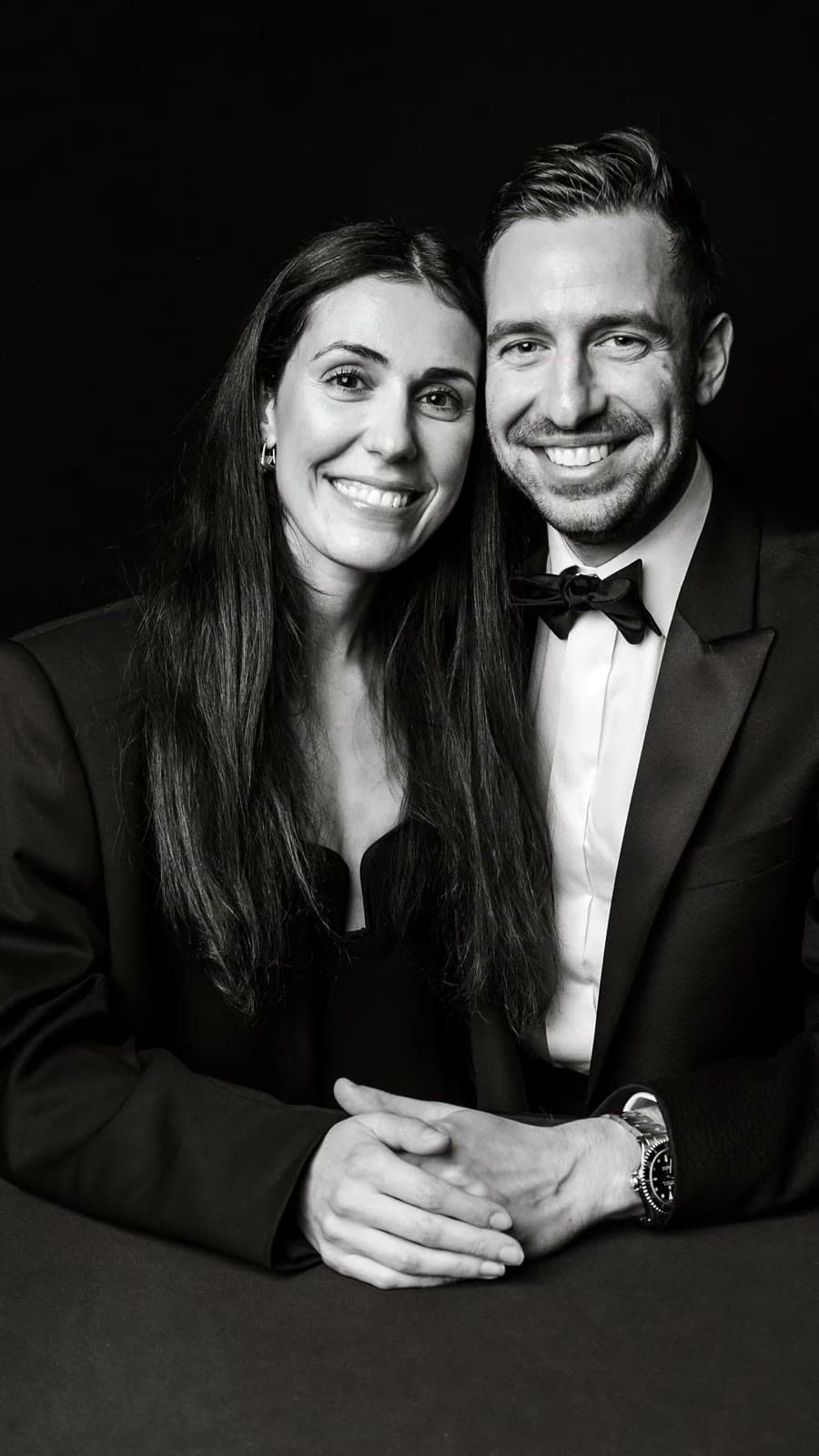 Couple in black tie on the black drape, black and white