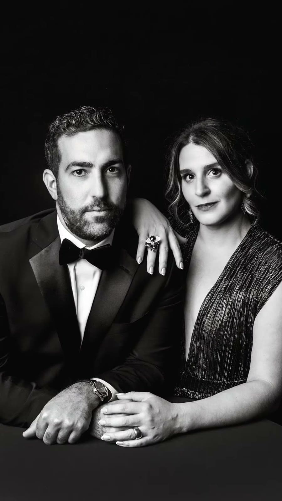 Two couples in black tie on the black drape