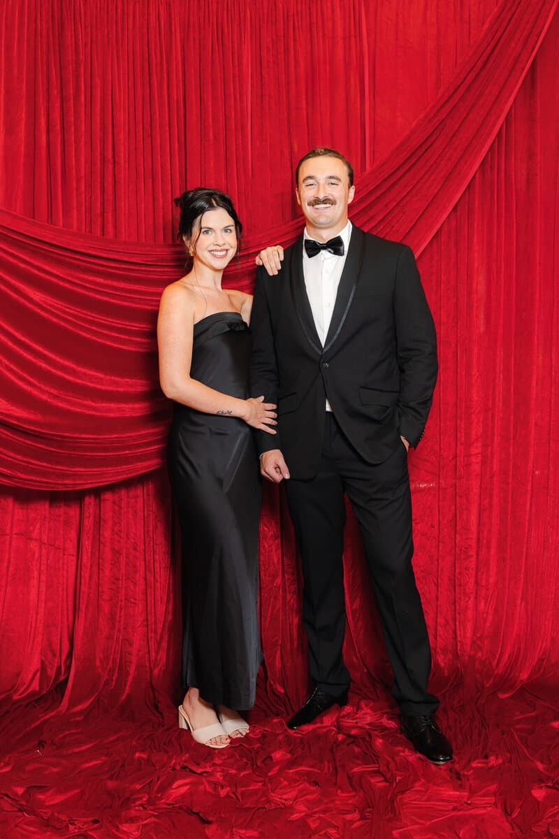 Couple standing on the red velvet set