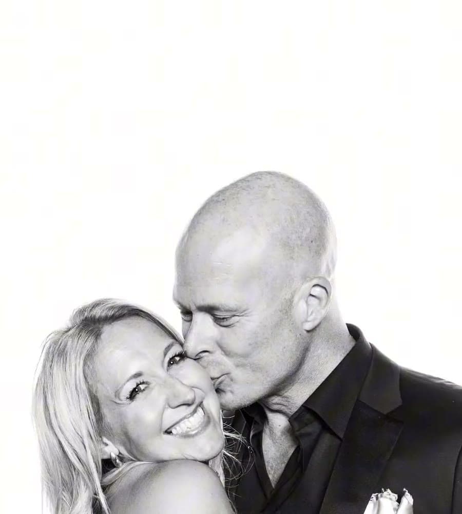 Couple kissing, high-key studio portrait